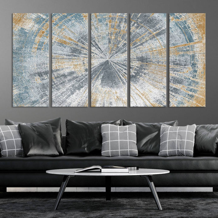 The Radiant Abstract Wood Rings Canvas Art, a modern triptych wall decor, enhances the contemporary style of the living room with its blue, white, and gold hues.