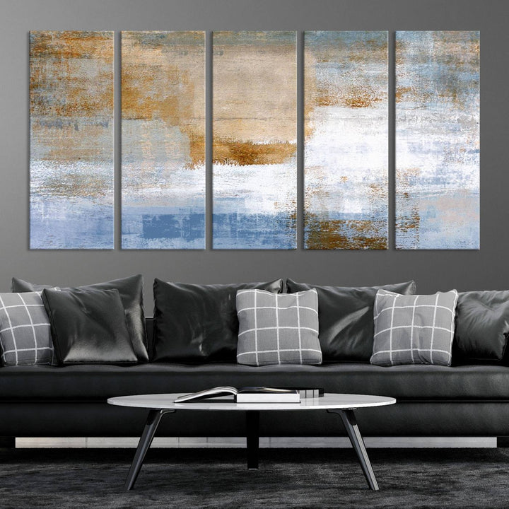 The Blue Multi Panel Abstract Wall Art Canvas Print, featuring an elegant blend of blue, beige, and brown tones, hangs gracefully on the wall, adding a contemporary touch to the space.