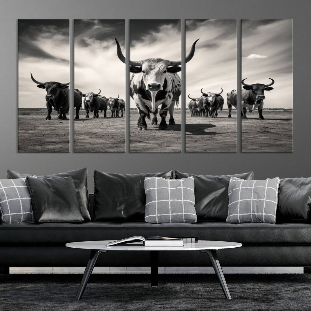 The Black and White Longhorn Cattle Wall Art, featuring a three-panel display of cowboy Western longhorns walking toward the viewer, enhances your space with its striking presence, adding a touch of Western decor.