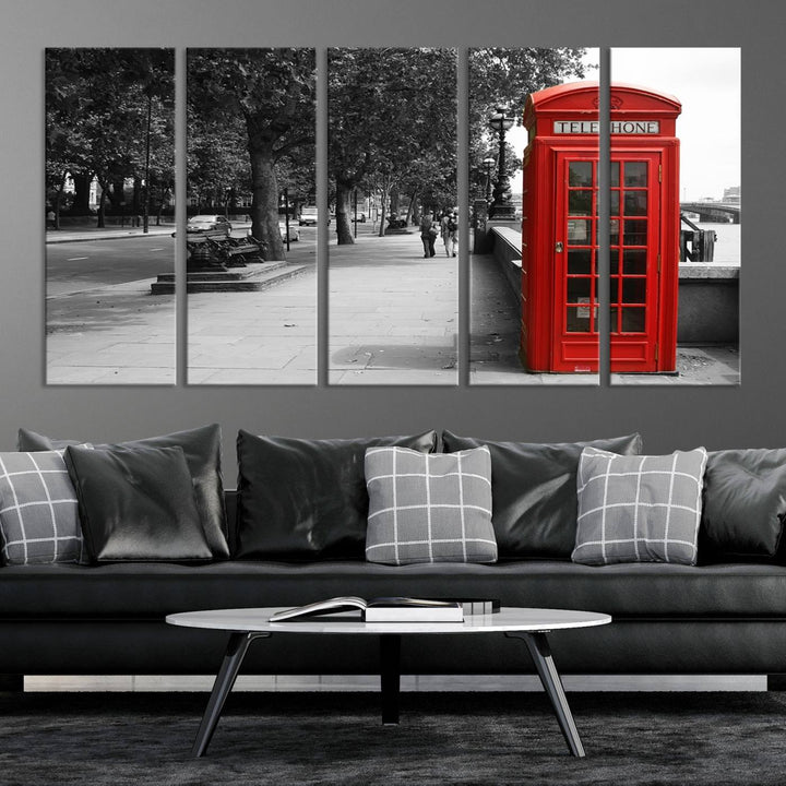 The London Phone Club Wall Art is a stunning piece that showcases a red telephone box set in a black and white street scene on museum-quality canvas. It is gallery wrapped with a UV-protective coating to preserve its vibrant charm.