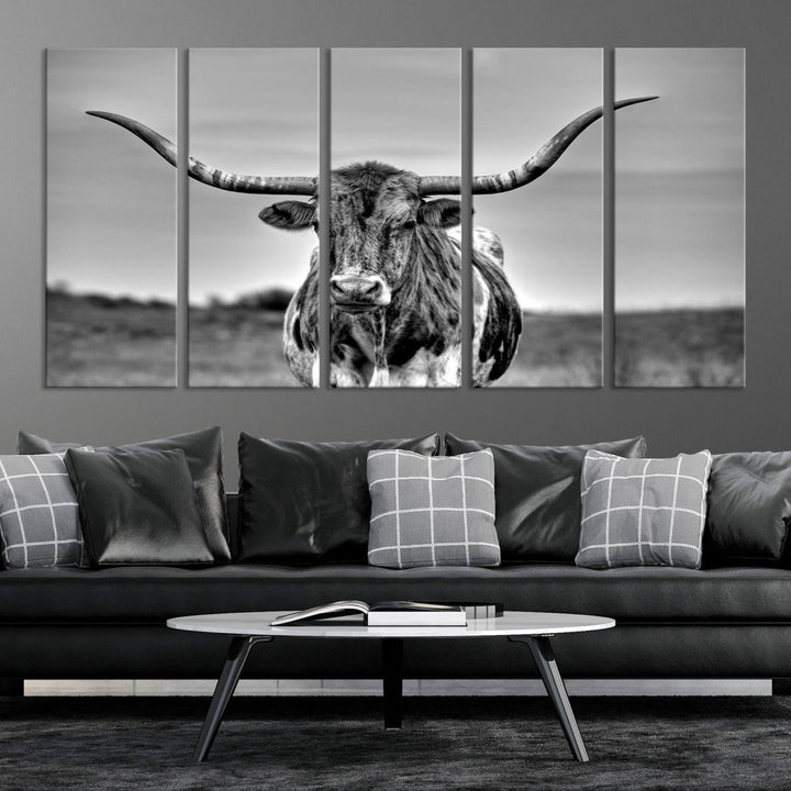 The Texas Longhorn Cow Wall Art, featuring a black and white image of a longhorn bull on canvas, brings charm to the room with its sophisticated appeal.