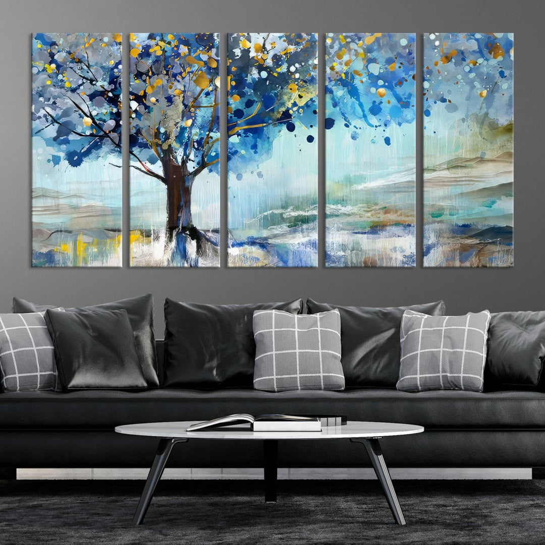 A modern living room features a three-panel Watercolor Style Abstract Tree Printing Wall Art Canvas in vibrant blue and yellow, crafted on museum-quality material.