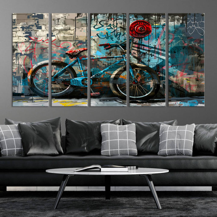 A modern living room features a triptych wall art of an abstract bicycle, designed in a graffiti style on a brick wall. This piece is expertly crafted on the Abstract Bicycle Wall Art Canvas Print, offering a premium canvas that ensures a gallery-quality finish.