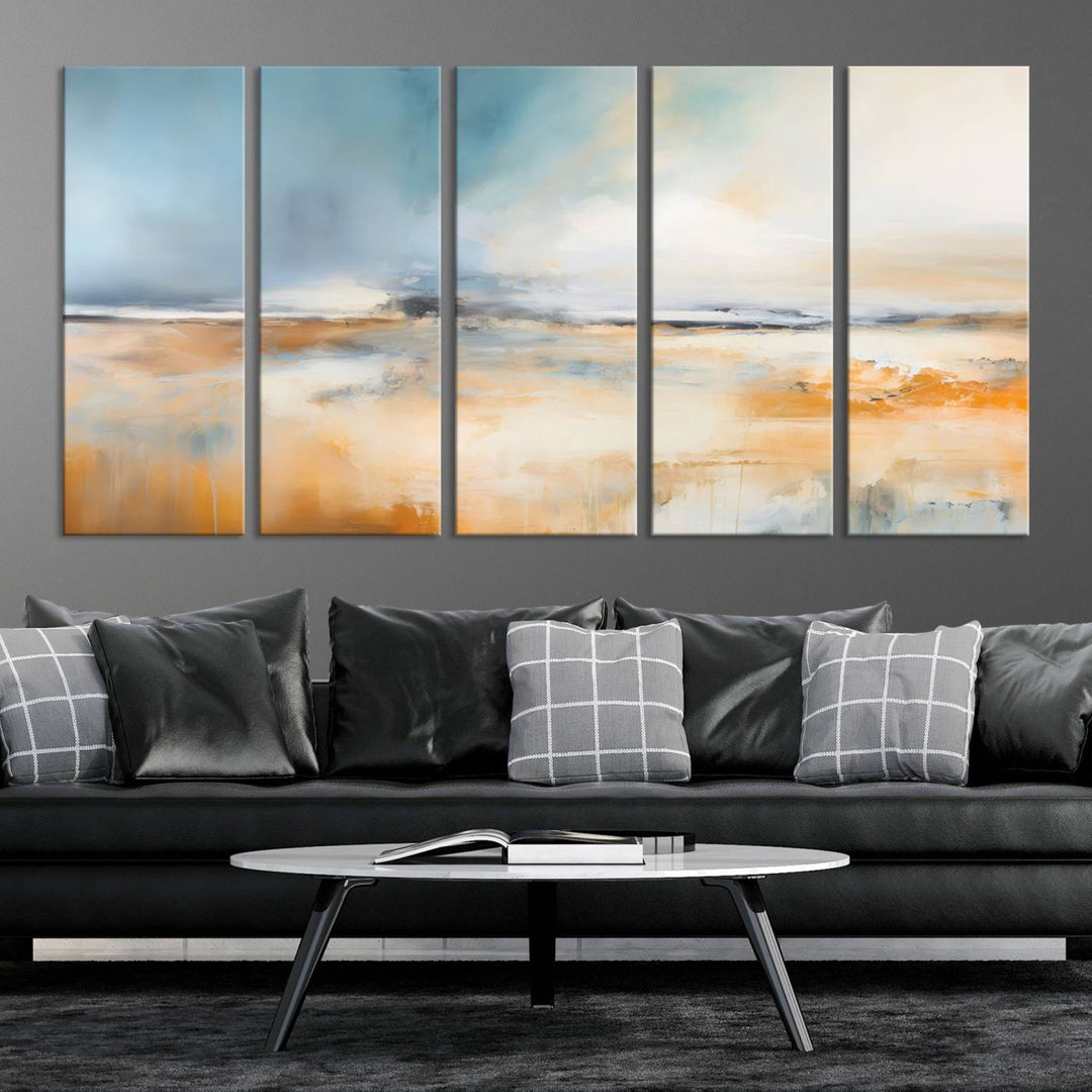 The Abstract Landscape Wall Art Canvas Print, featuring warm tones of orange and blue, is displayed on a dark wall.