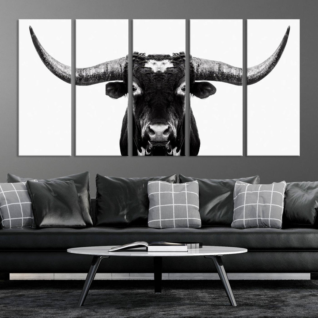 The living room is adorned with the Texas Cow Longhorn Wall Art Canvas Print in Black and White—framed and ready to hang.