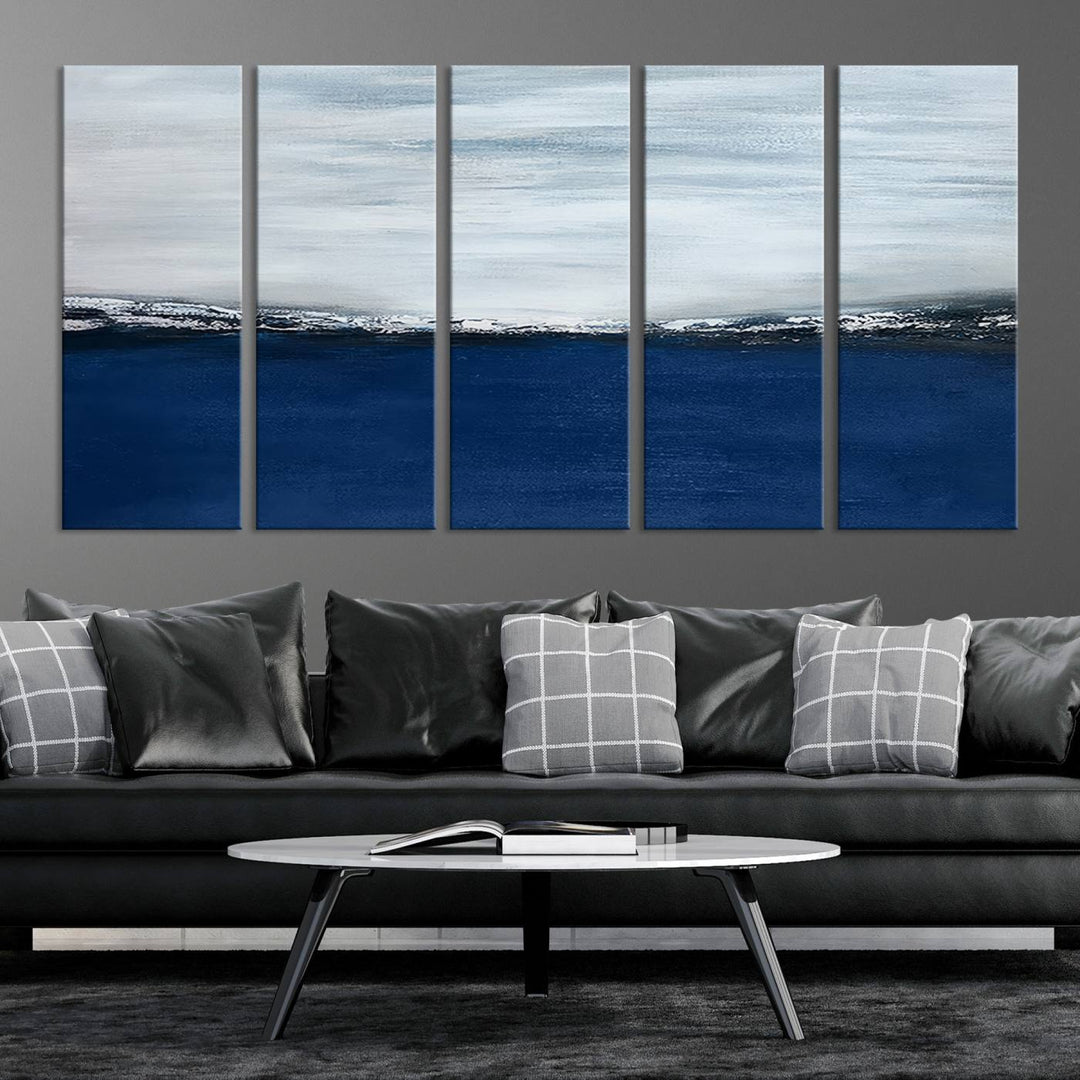 The modern living room is enhanced by the Navy Blue Abstract Wall Art Canvas Print on the wall, crafted as handmade wall art with a gallery-quality finish.