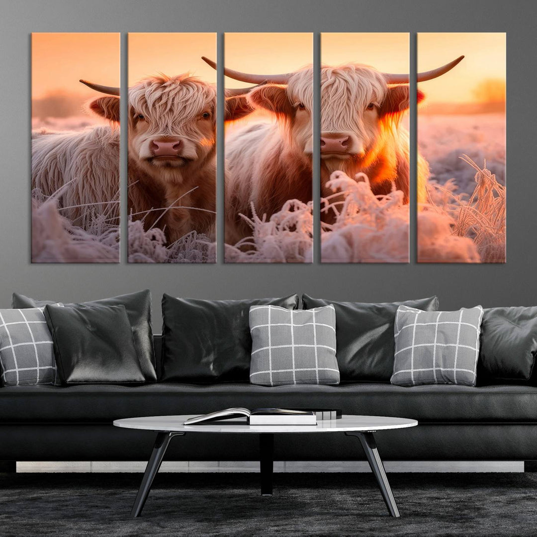 The "Highland Cows at Sunrise Wall Art Canvas Set" beautifully captures a serene and rustic farmhouse aesthetic, portraying two Highland cows in a frosty landscape at sunrise.