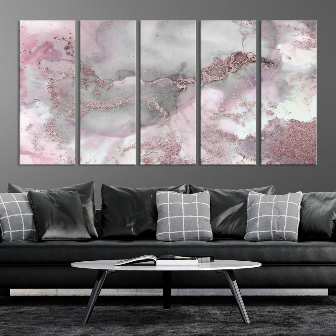 The Rose Marble Abstract Wall Art Canvas Print is a stunning triptych that showcases pink and gray tones, elegantly presented on a dark wall.