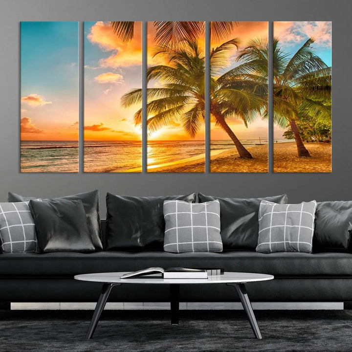 The Tropical Sunset Wall Art Print features a vibrant beach scene with palm trees and an ocean view highlighted by a golden sunset.