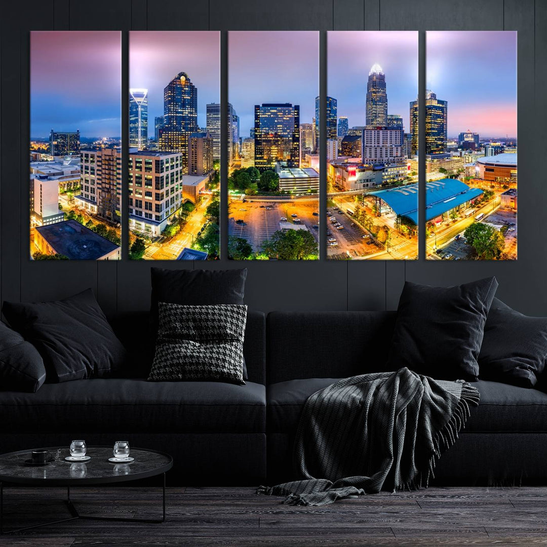 The living room features three large pieces of the *Charlotte City Lights Sunset Purple Skyline Cityscape View Wall Art Canvas Print*. Crafted on gallery-wrapped, museum-quality canvas with UV-protective coating, they grace the wall and add an artistic flair to the space.