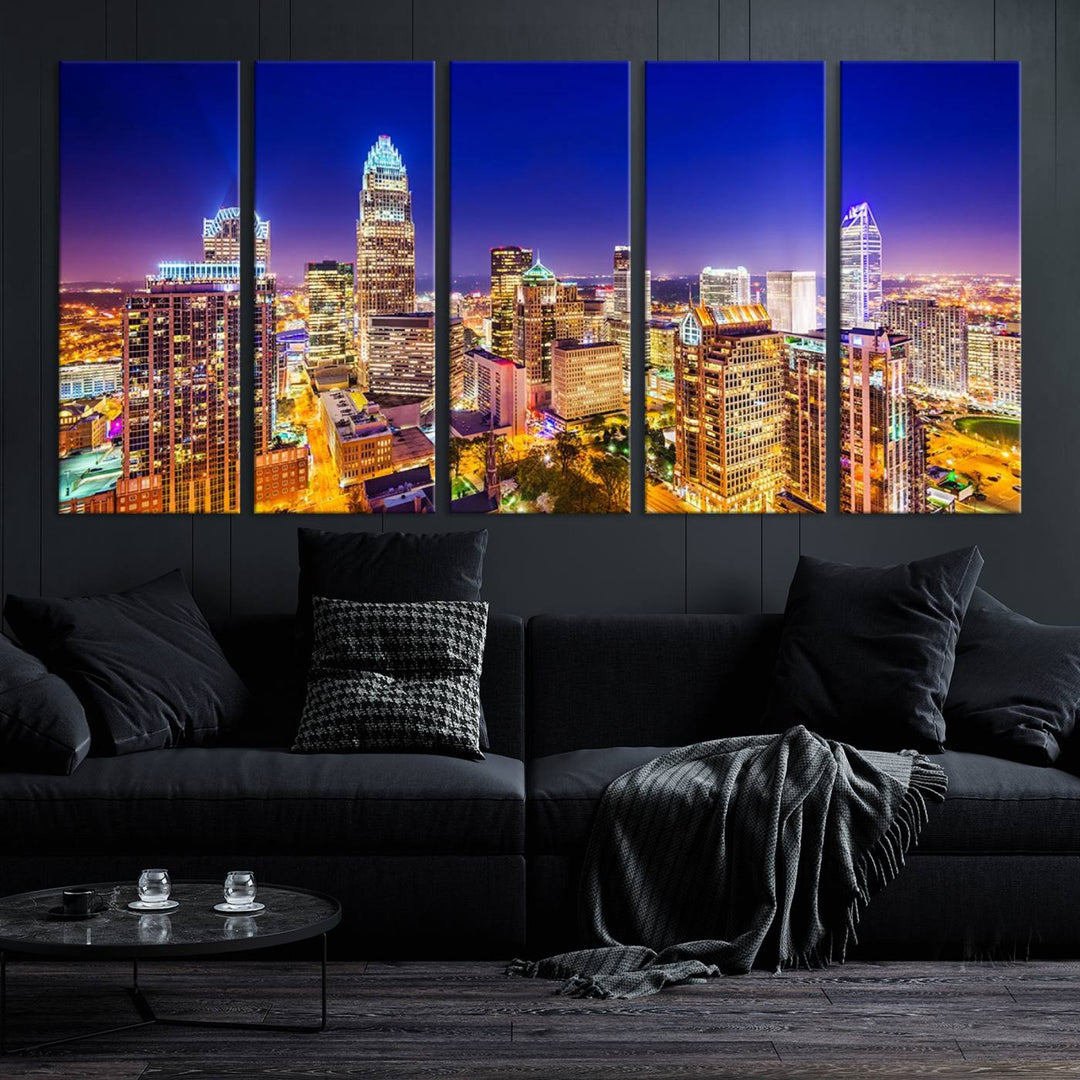 A modern living room features the Charlotte City Lights Night Blue Skyline Cityscape View wall art canvas print.