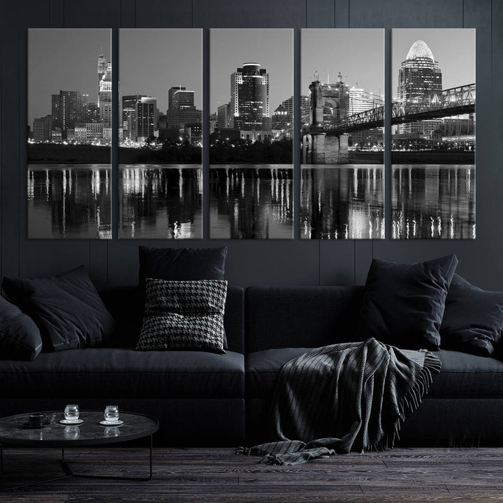 The wall showcases a ready-to-hang triptych of the Cincinnati City Lights Skyline in black and white, printed on museum-quality canvas.