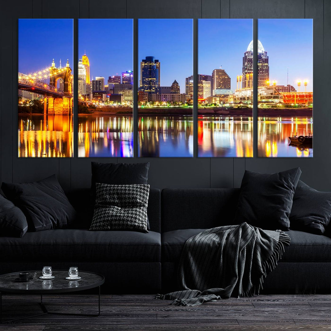 The "Cincinnati City Lights Night Skyline Cityscape View Wall Art Canvas Print" is a gallery-wrapped, museum-quality canvas illustrating a lit-up bridge and skyline at night. Enhanced with a UV-protective coating, this piece ensures lasting vibrancy.