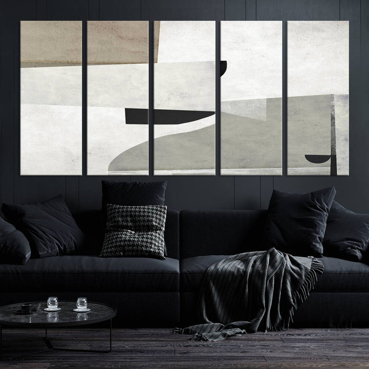 The Brown Gray Figures Abstract Wall Art Canvas Print is displayed as a triptych on a dark wall. The piece is gallery wrapped, offering a seamless finish and enhanced durability due to its UV-protective coating.