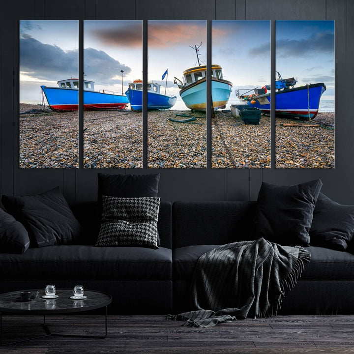 The "Big Boats On The Beach Wall Art Canvas Print" is a stunning piece featuring three museum-quality panels depicting fishing boats on a pebbled shore. Ready to hang and featuring UV-protective coating, it serves as an elegant addition to your home décor.