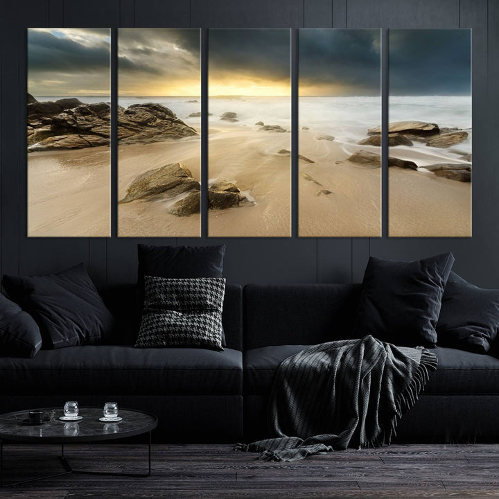 A gallery-wrapped, three-panel artwork titled "Rocks and Waves Wall Art Canvas Print" depicts a rocky beach at sunset. Each canvas showcases museum-quality craftsmanship and a UV-protective coating to maintain its vibrant colors.