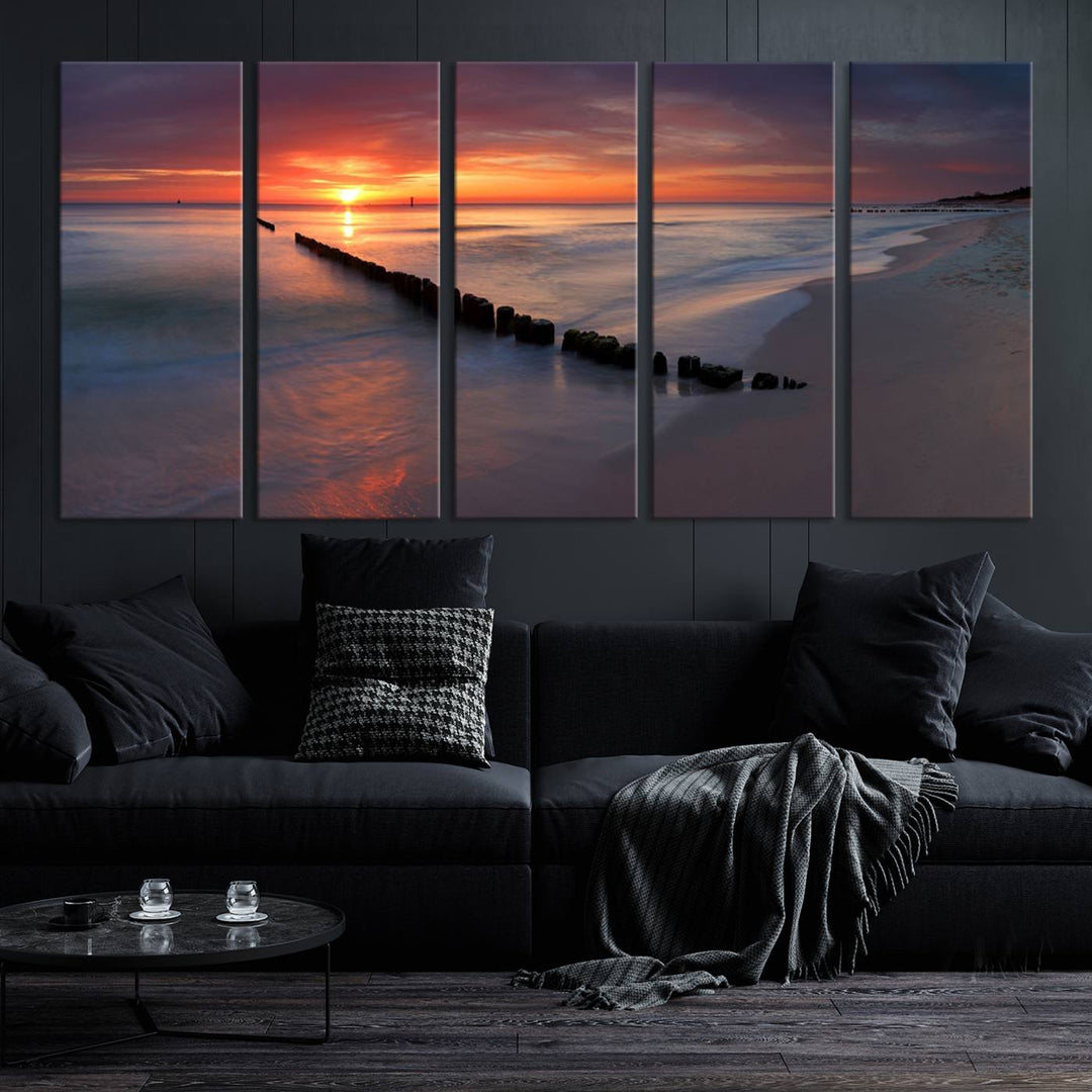 In a modern living room, the Sunset Beach Wall Art Canvas Print is displayed above. This triptych, printed on museum-quality canvas with a UV-protective coating, ensures lasting brilliance. It's ready to hang and brings an elegant touch to your space.