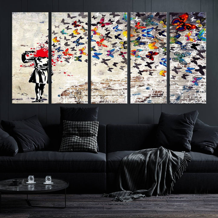 The Banksy Art Butterfly Girl Explosion Canvas showcases a dynamic figure with butterflies bursting from their head, set against a textured wall background. This vibrant urban graffiti piece is perfect for modern interiors and comes ready to hang.