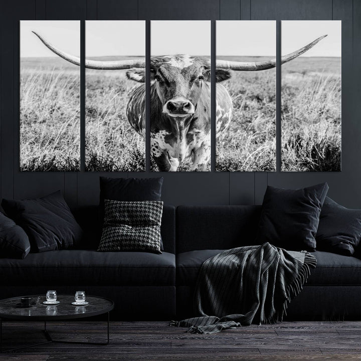 The Texas Cow Longhorn Wall Art Canvas Print is a black and white triptych depicting a cow in a field. It is crafted with museum-quality canvas and features a UV-protective coating.