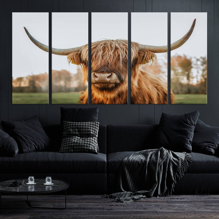 A Highland Cow Animal Scottish Cattle Art Print Farmhouse Wall Art Canvas Print hangs in the living room, adding a touch of rustic farmhouse decor.