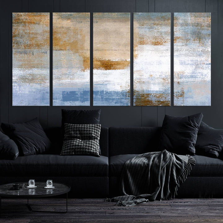 The Blue Multi Panel Abstract Wall Art Canvas Print, featuring an elegant blend of blue, beige, and brown tones, hangs gracefully on the wall, adding a contemporary touch to the space.