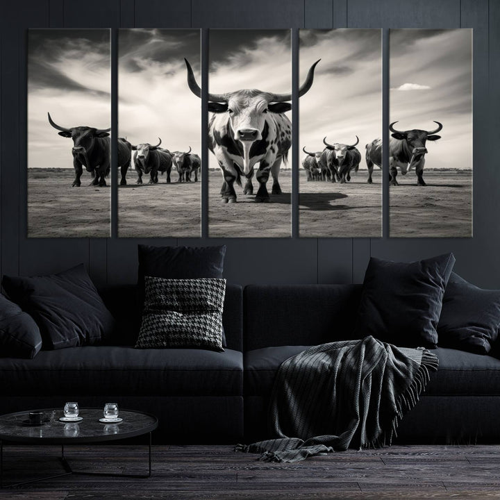 The Black and White Longhorn Cattle Wall Art, featuring a three-panel display of cowboy Western longhorns walking toward the viewer, enhances your space with its striking presence, adding a touch of Western decor.