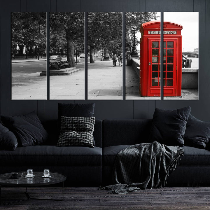 The London Phone Club Wall Art is a stunning piece that showcases a red telephone box set in a black and white street scene on museum-quality canvas. It is gallery wrapped with a UV-protective coating to preserve its vibrant charm.