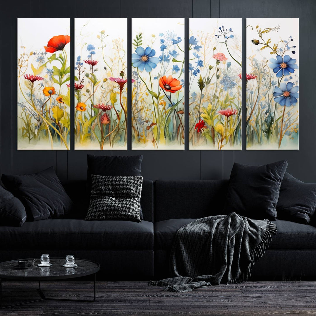 The Colorful Wildflower Canvas Wall Art – Vibrant Floral Botanical Print, consisting of a large 3 panel set, adds bright nature decor to the living room against a black wall.