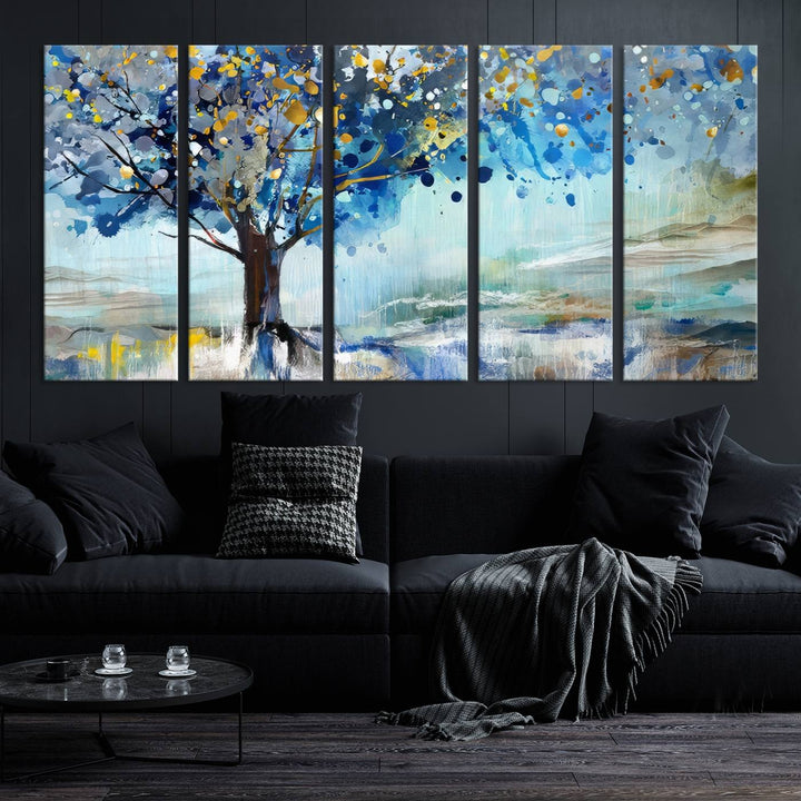 A modern living room features a three-panel Watercolor Style Abstract Tree Printing Wall Art Canvas in vibrant blue and yellow, crafted on museum-quality material.