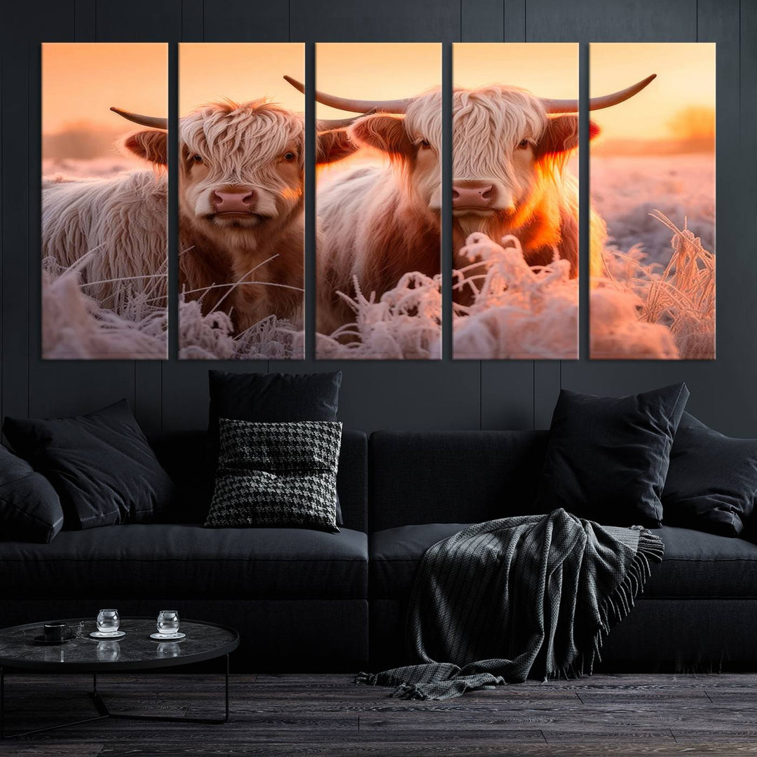 The "Highland Cows at Sunrise Wall Art Canvas Set" beautifully captures a serene and rustic farmhouse aesthetic, portraying two Highland cows in a frosty landscape at sunrise.