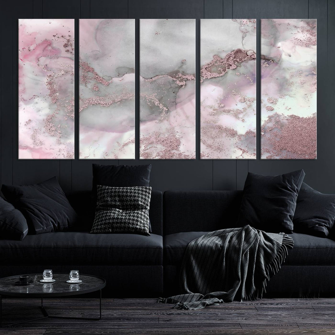 The Rose Marble Abstract Wall Art Canvas Print is a stunning triptych that showcases pink and gray tones, elegantly presented on a dark wall.