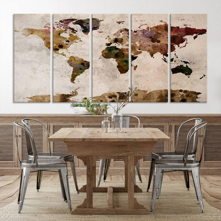 A Watercolor World Map Canvas Print, wrapped in an elegant gallery style, hangs on the wall.