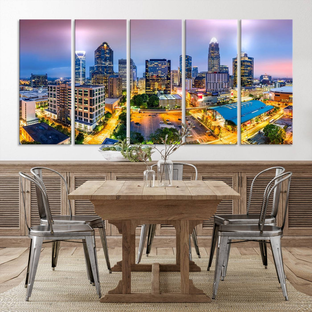 The living room features three large pieces of the *Charlotte City Lights Sunset Purple Skyline Cityscape View Wall Art Canvas Print*. Crafted on gallery-wrapped, museum-quality canvas with UV-protective coating, they grace the wall and add an artistic flair to the space.