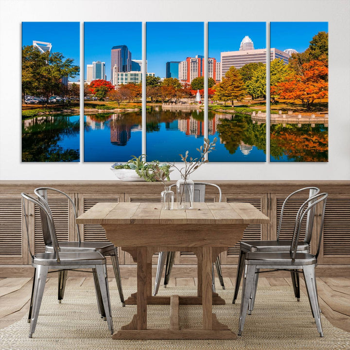 The "Charlotte City Autumn Morning Blue Skyline Cityscape View Wall Art Canvas Print" showcases a cityscape with vibrant autumn trees reflected in a lake. Its gallery-wrapped edges add depth to the scene, while the UV-protective coating ensures lasting brilliance.