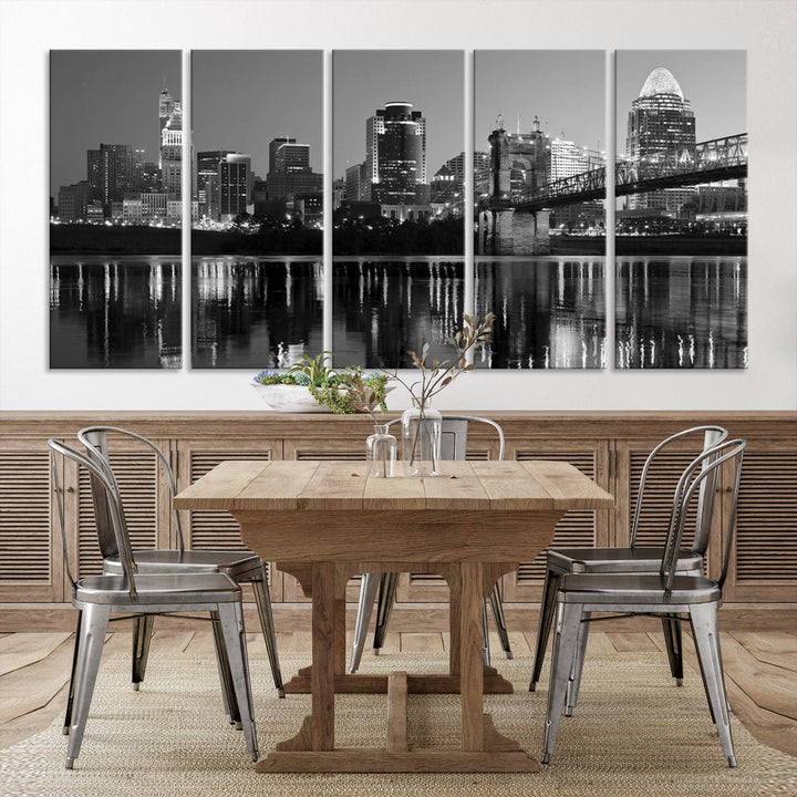 The wall showcases a ready-to-hang triptych of the Cincinnati City Lights Skyline in black and white, printed on museum-quality canvas.