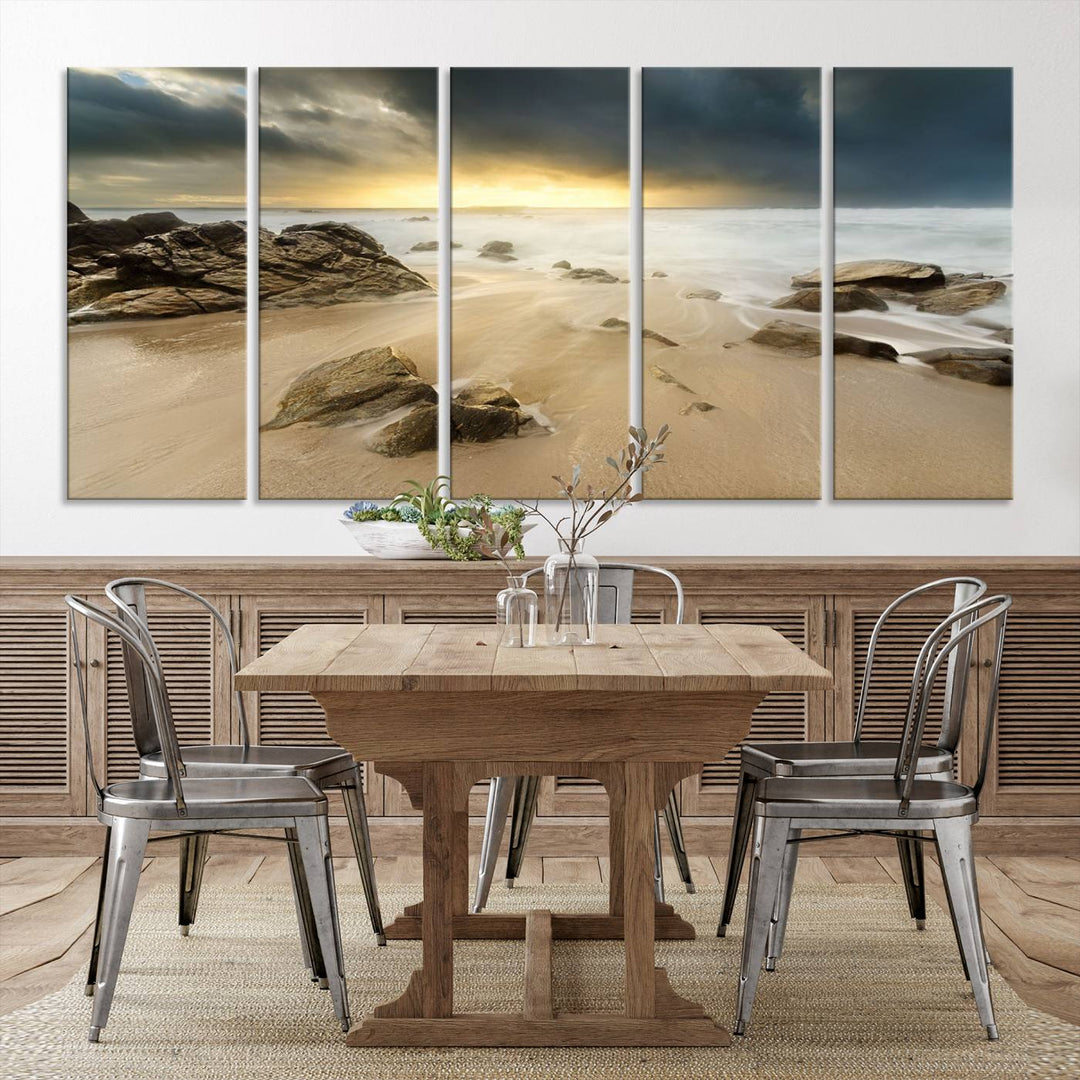 A gallery-wrapped, three-panel artwork titled "Rocks and Waves Wall Art Canvas Print" depicts a rocky beach at sunset. Each canvas showcases museum-quality craftsmanship and a UV-protective coating to maintain its vibrant colors.