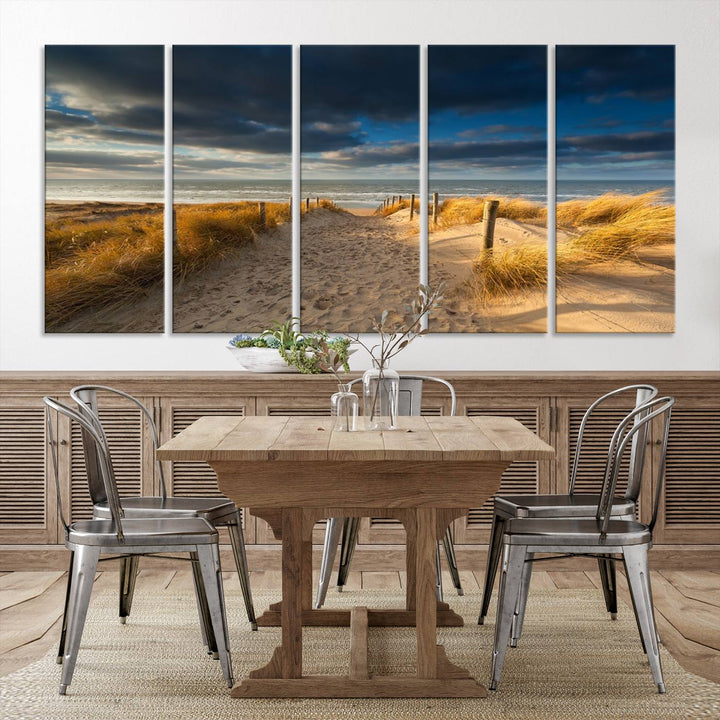 The Ocean Beach Dark Clouds Wall Art Canvas Print is a breathtaking triptych depicting a sandy beach path with tall grasses under an intense cloudy sky. It is crafted on museum-quality canvas with UV protection.