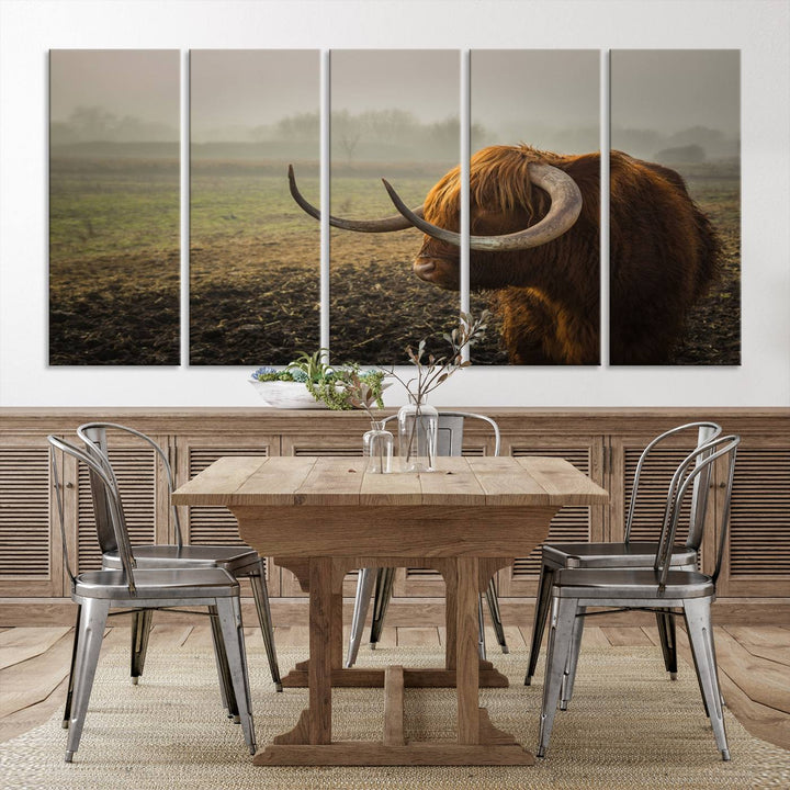 The "Big Cow Horn Wall Art Canvas Print" is a hand-assembled framed canvas depicting a Highland cow in a misty field. It is crafted with a UV-protective coating to ensure lasting vibrancy.