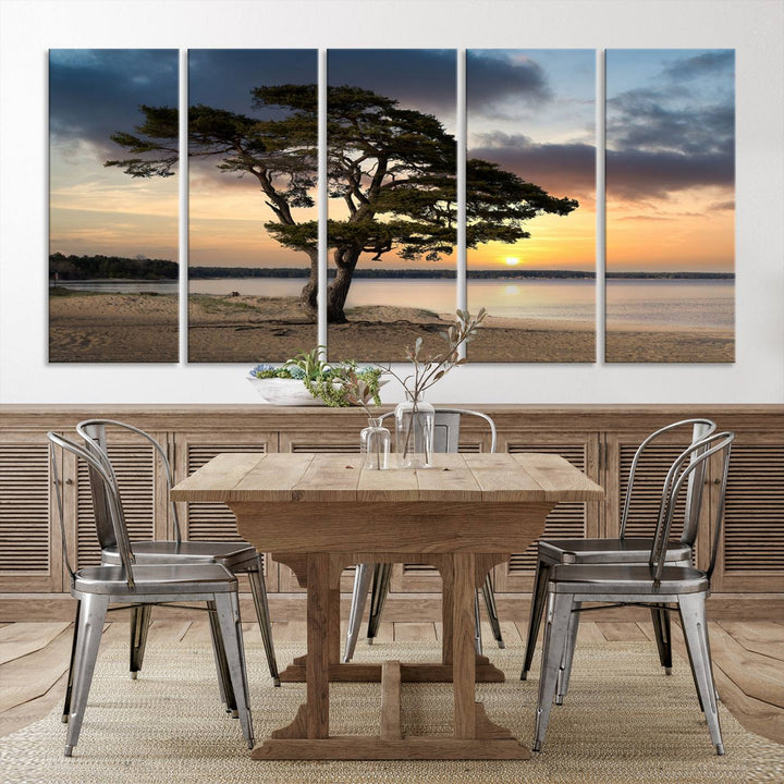 The room showcases the Coastal Sunset Wall Art Canvas Print, a triptych elegantly displayed on museum-quality polycotton canvas, depicting a serene beach sunset with a tree.