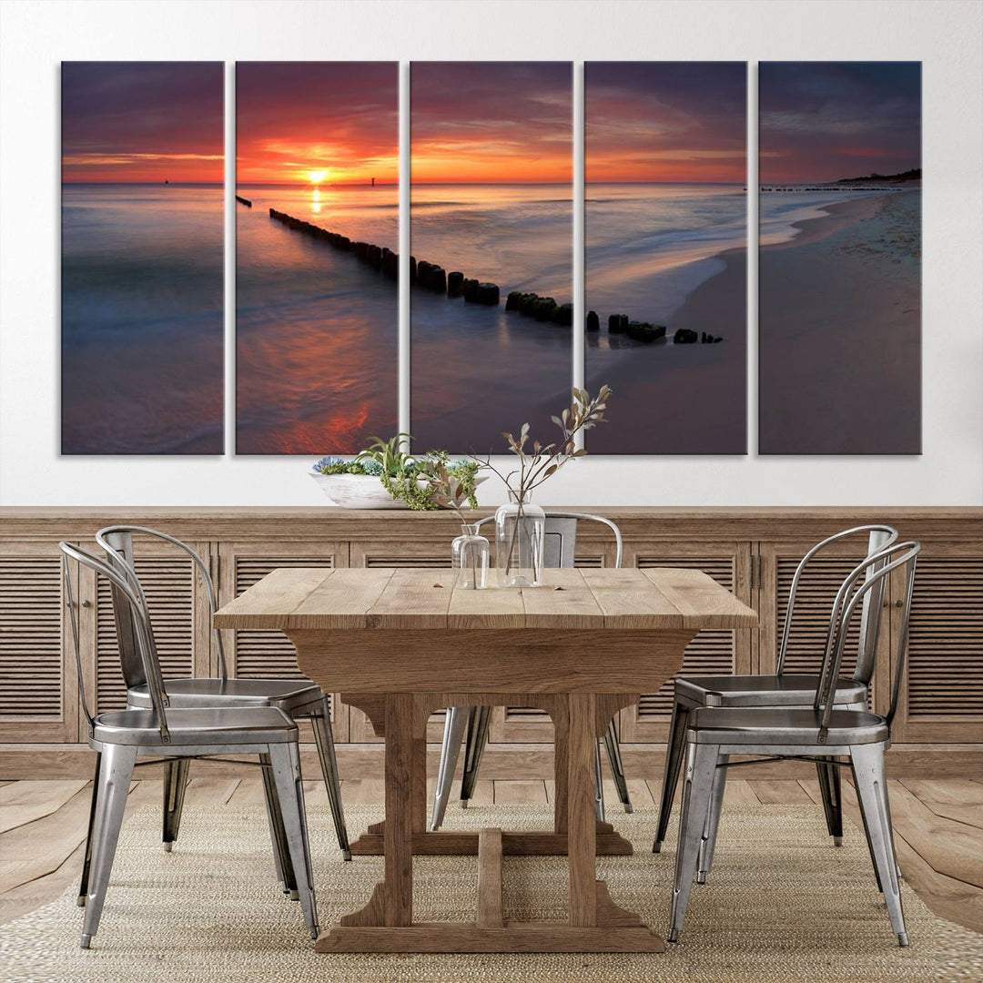 In a modern living room, the Sunset Beach Wall Art Canvas Print is displayed above. This triptych, printed on museum-quality canvas with a UV-protective coating, ensures lasting brilliance. It's ready to hang and brings an elegant touch to your space.