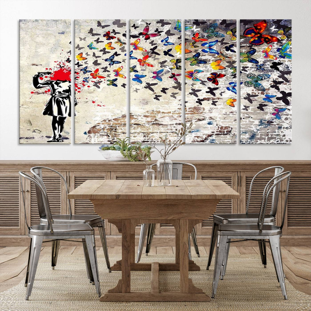 The Banksy Art Butterfly Girl Explosion Canvas showcases a dynamic figure with butterflies bursting from their head, set against a textured wall background. This vibrant urban graffiti piece is perfect for modern interiors and comes ready to hang.