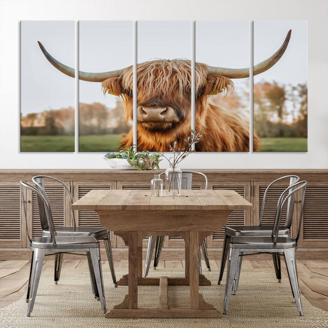 A Highland Cow Animal Scottish Cattle Art Print Farmhouse Wall Art Canvas Print hangs in the living room, adding a touch of rustic farmhouse decor.