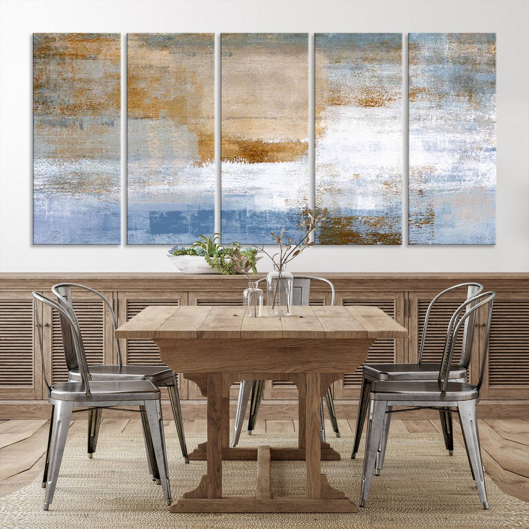 The Blue Multi Panel Abstract Wall Art Canvas Print, featuring an elegant blend of blue, beige, and brown tones, hangs gracefully on the wall, adding a contemporary touch to the space.