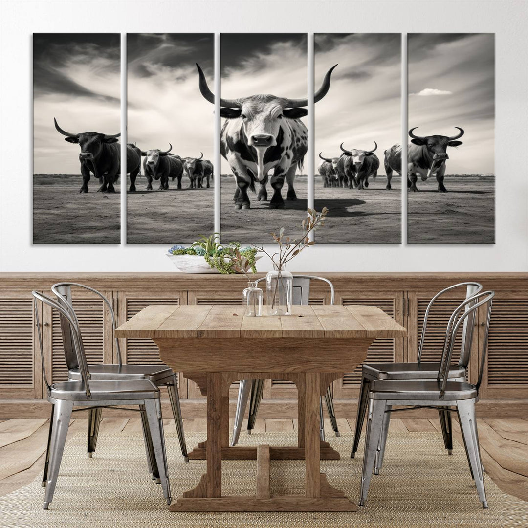 The Black and White Longhorn Cattle Wall Art, featuring a three-panel display of cowboy Western longhorns walking toward the viewer, enhances your space with its striking presence, adding a touch of Western decor.