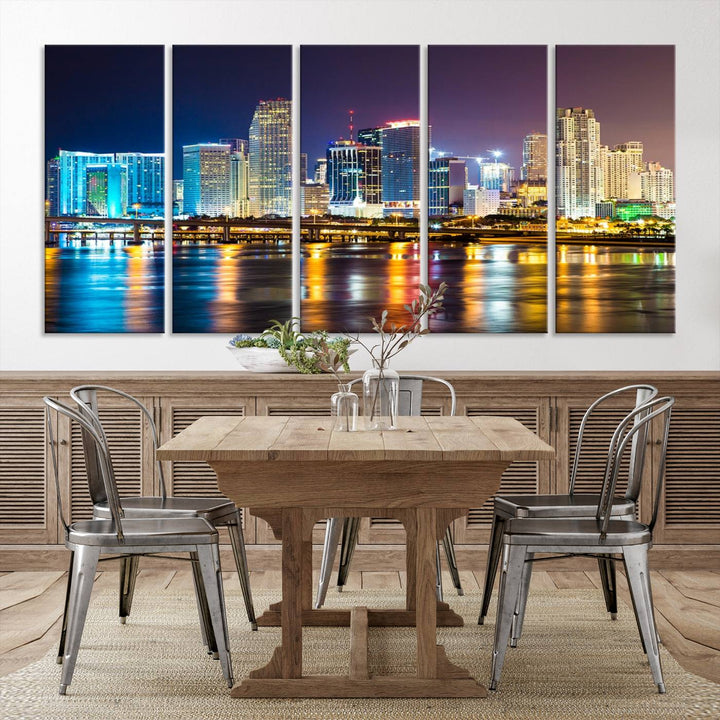 The Wall Art MIAMI Canvas Print features a stunning triptych of a city skyline at night, with vibrant lights reflecting on the water. This gallery-wrapped piece on museum-quality canvas delivers an exquisite finish.