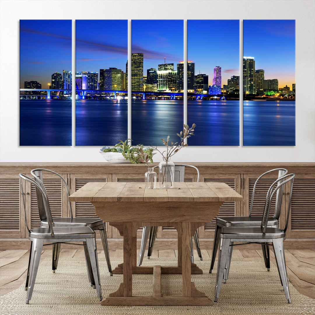 The modern living room showcases a striking Miami Blue Night Wall Art canvas print on the wall. The artwork is gallery wrapped on museum-quality canvas, ensuring durability and elegance.