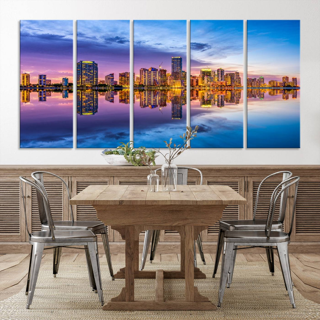 The Miami City Wall Art Canvas Print, featuring a three-panel depiction of a city skyline at sunset reflected in water, beautifully enhances the wall. Made with museum-quality canvas and a UV-protective coating, it comes ready to hang.