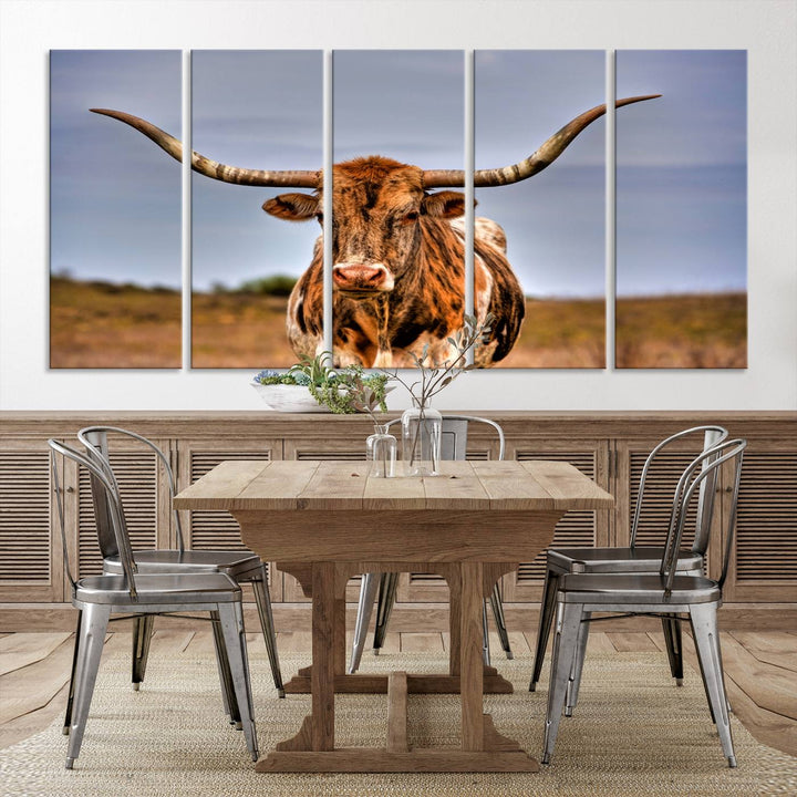 The Texas Longhorn Wall Art Print, a triptych canvas artwork depicting a longhorn bull in a field, features a gallery-quality finish.