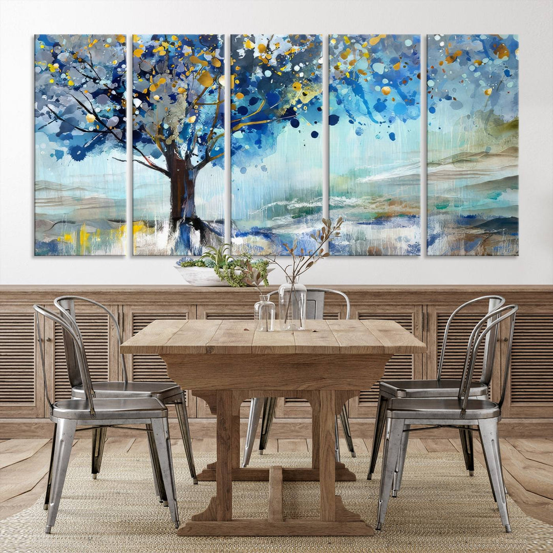 A modern living room features a three-panel Watercolor Style Abstract Tree Printing Wall Art Canvas in vibrant blue and yellow, crafted on museum-quality material.