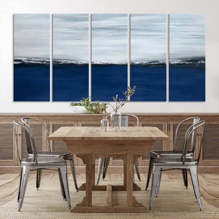 The modern living room is enhanced by the Navy Blue Abstract Wall Art Canvas Print on the wall, crafted as handmade wall art with a gallery-quality finish.